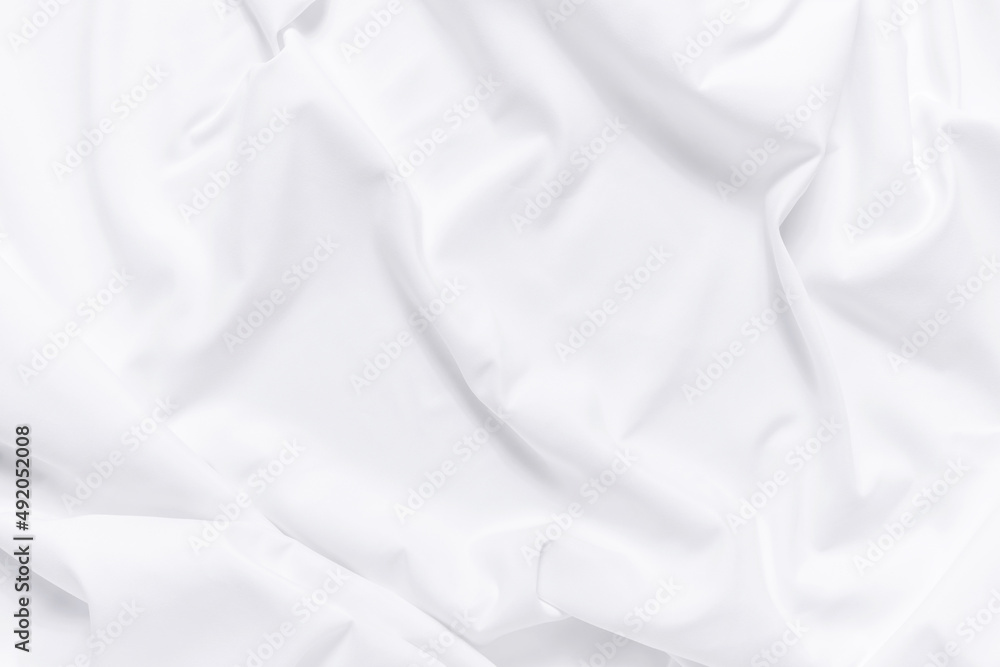 Fototapeta premium White fabric texture background. Cloth soft wave. Creases of satin, silk, and cotton.