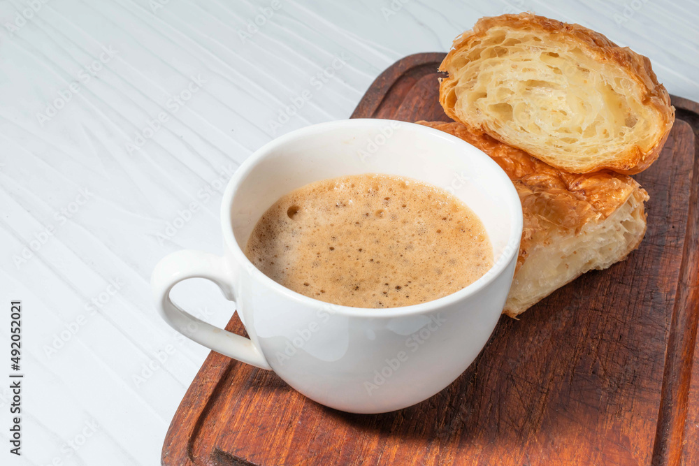 Breakfast food coffee and croissant on white wood table. Breakfast food coffee and croissant on white wood table.