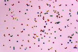 Festive pink background with many colorful stars and moons. Christmas, New Year or Birthday theme concept. An ideal backdrop for your banner or web design. Backplate for happy holidays presentation