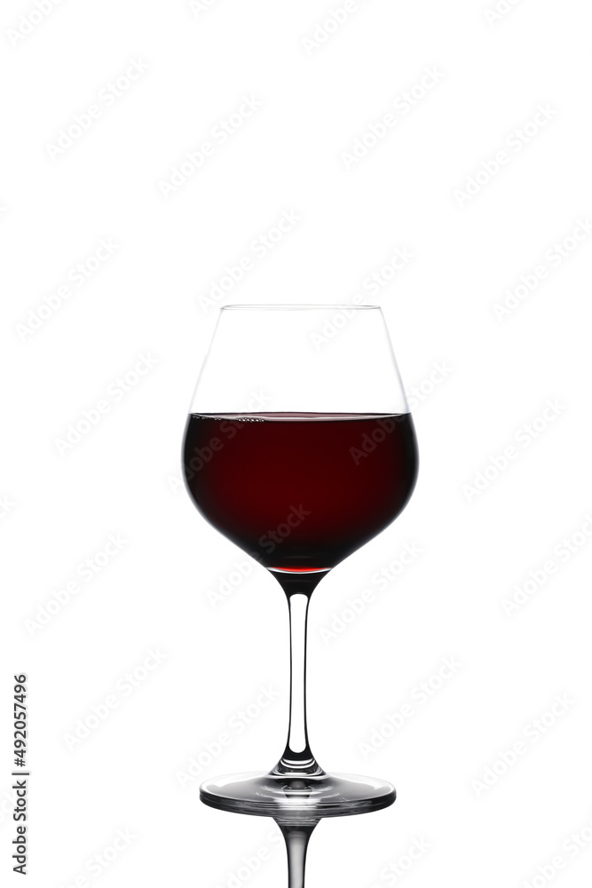 red wine in a glass glass stands on a white background red wine in a glass glass stands on a white background