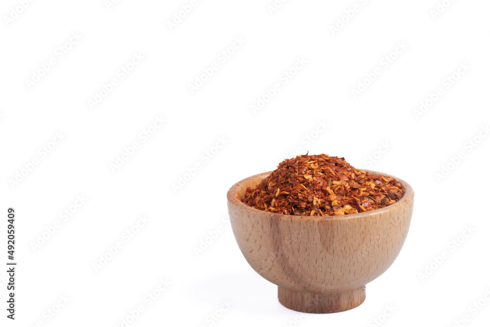 dried chili peppers in a wooden cup on a white background dried chili peppers in a wooden cup on a white background