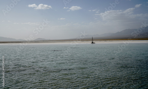 Chaka Salt Lake and Saline-alkali land landscape with blue sky and Snow mountain background in northwest China. photo