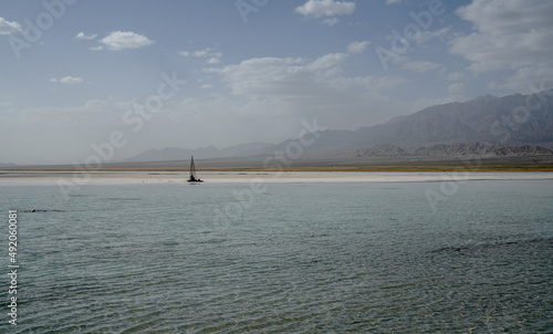 Chaka Salt Lake and Saline-alkali land landscape with blue sky and Snow mountain background in northwest China. photo