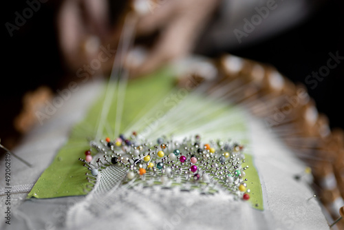 Unrecognizable embroiderer making bobbin lace
