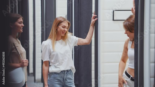 Wallpaper Mural Shopping with friends, young female showing her new outfit to besties in dressing room. Handheld women having fun choosing clothes together. Concept of consumerism Torontodigital.ca
