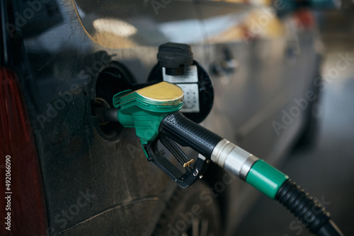 Close-up of filling gas into car gas tank.