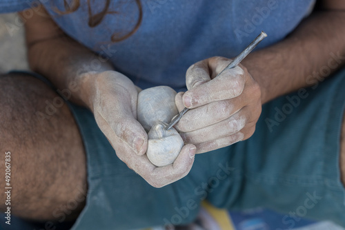 Obraz na plátne Male hands carve stone sculpture in India,