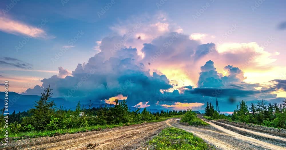 Timelapse. The fantastic colors of the sunset are cumulus clouds that rise above the sun. There are many insects in the air - many pets pass along the road Timelapse. The fantastic colors of the sunset are cumulus clouds that rise above the sun. There are many insects in the air - many pets pass along the road