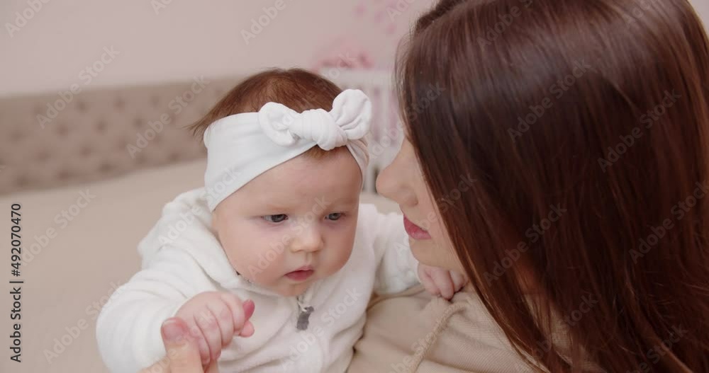 Caucasian newborn baby with mom. The concept of childhood, new life and fatherhood Caucasian newborn baby with mom. The concept of childhood, new life and fatherhood