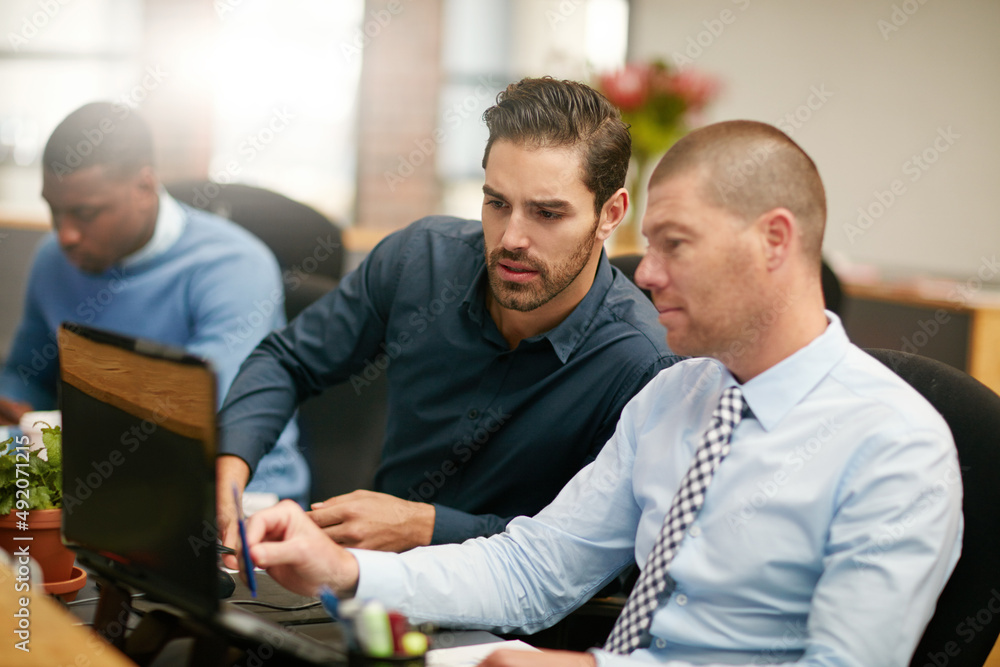 Hes always willing to help. Cropped shot of three businessmen working in the office. Hes always willing to help. Cropped shot of three businessmen working in the office.