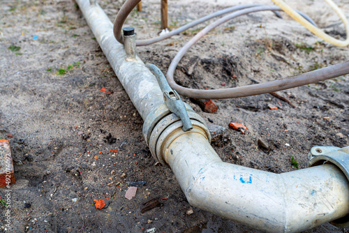 Wellpoint installation to get rid of high groundwater, visible steel tube with a latch.