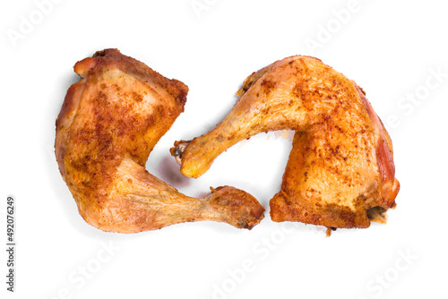 Fresh roasted chicken leg quarters on white isolated background.