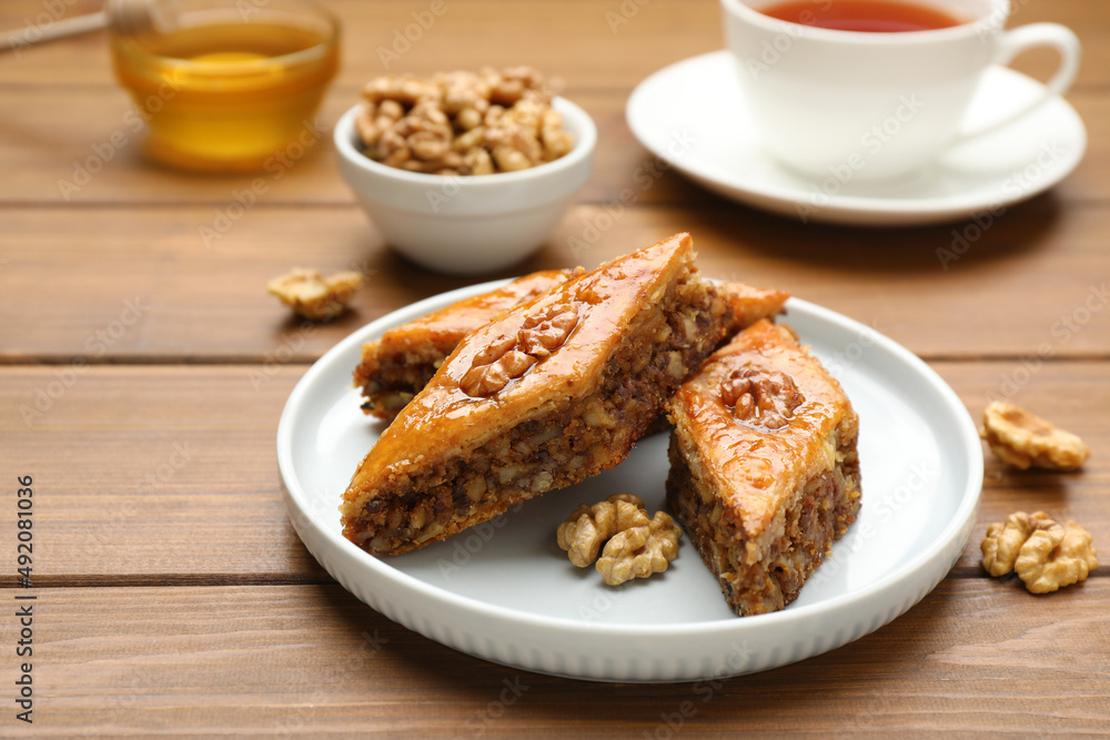 Delicious honey baklava with walnuts served on wooden table