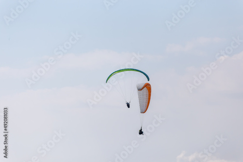 Paraplaners with beautiful blue sky and clounds in the background photo