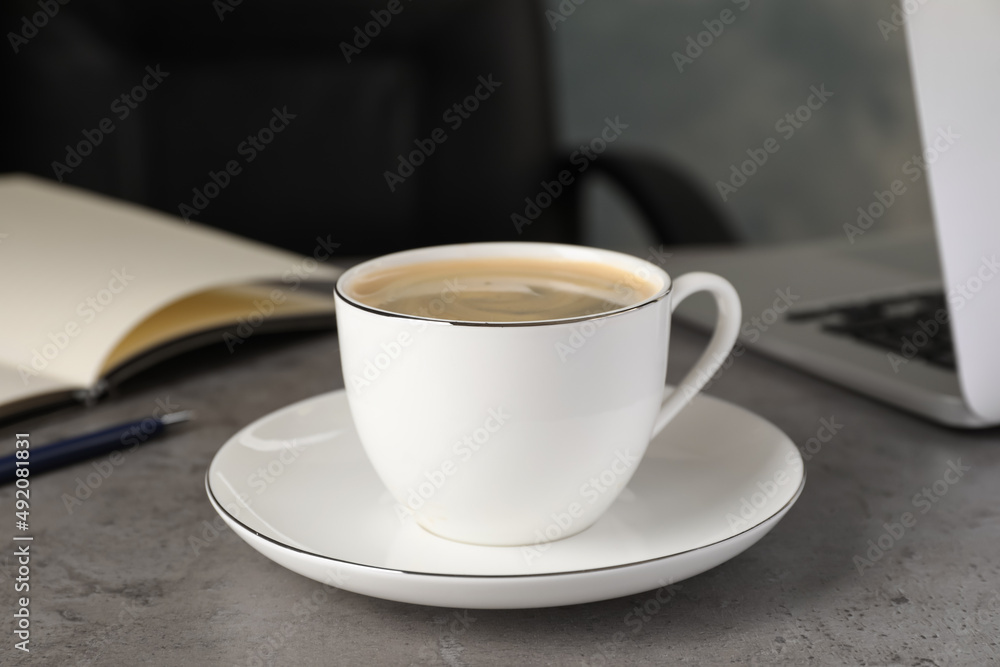 Cup of americano on grey table in office. Coffee Break Cup of americano on grey table in office. Coffee Break