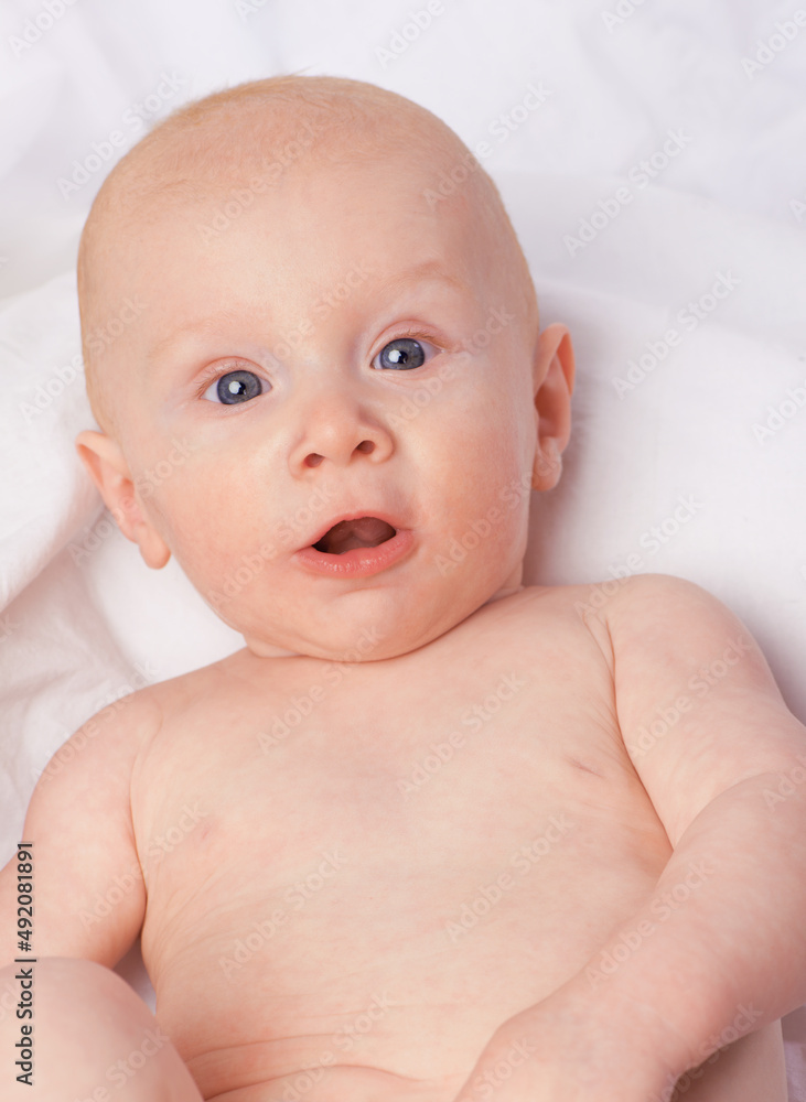 Hes his moms little angel. Cropped shot of an adorable baby boy in a studio. Hes his moms little angel. Cropped shot of an adorable baby boy in a studio.