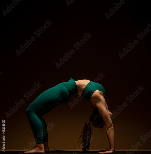 Doing the chakrasana pose while focusing on her breathing