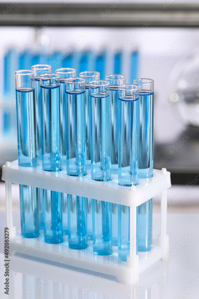 Test tubes with reagents on table in laboratory Test tubes with reagents on table in laboratory