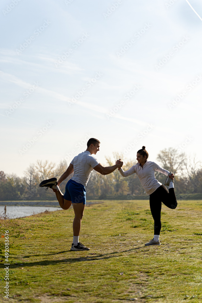 Balancing on one leg while holding each other and talking outside Balancing on one leg while holding each other and talking outside