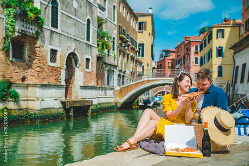 couple having date at pier with beautiful view of venice canal
