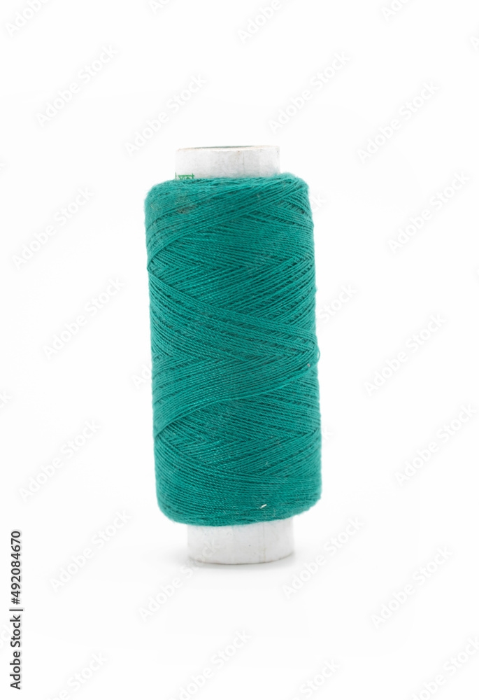 DarkCyan yarn on spool, yarn on tube, cotton, wool, linen thread, isolate on white background DarkCyan yarn on spool, yarn on tube, cotton, wool, linen thread, isolate on white background