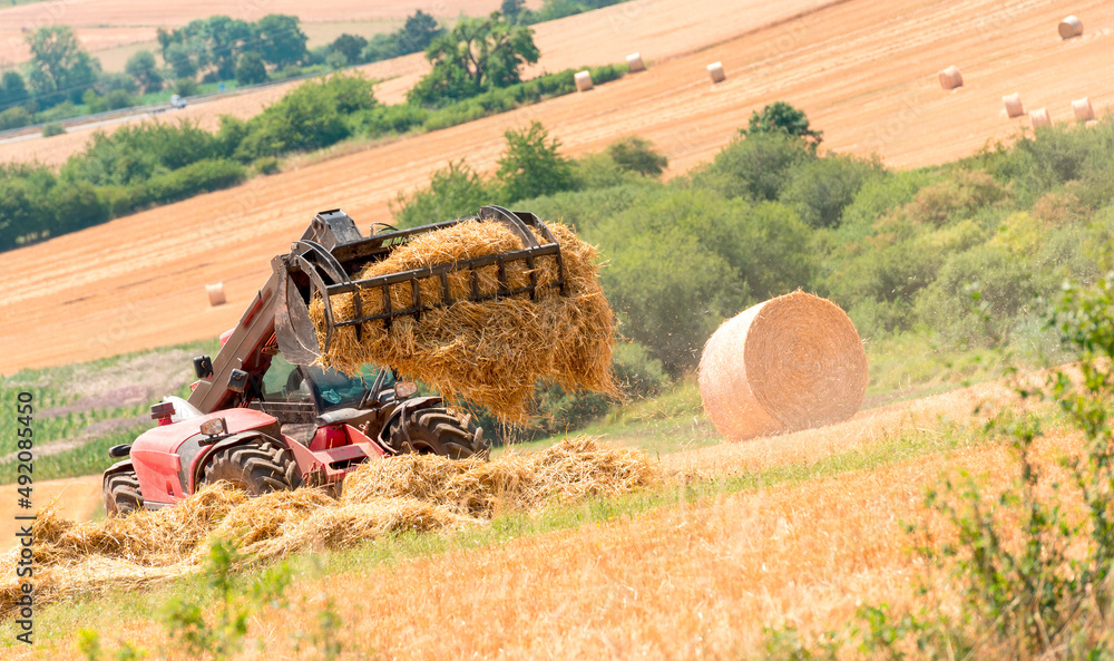 Obraz premium tractor at work in a field after harvest