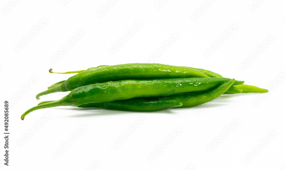 green chili pepper slices isolated on wooden background with clipping path green chili pepper slices isolated on wooden background with clipping path