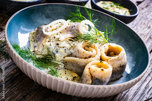Konstfotografi Swedish style marinated herring fillets in mayonnaise and cream with pickled cuc
