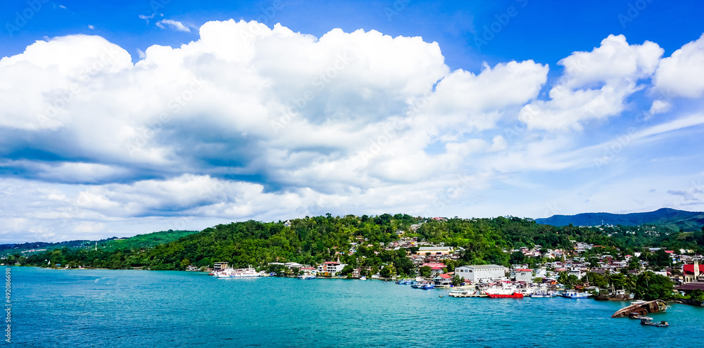 The mountainous coast in Ambon City is densely packed with buildings but has clean beaches