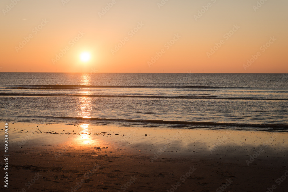 sunset on the beach over sea on red, orange and yellow colors sunset on the beach over sea on red, orange and yellow colors