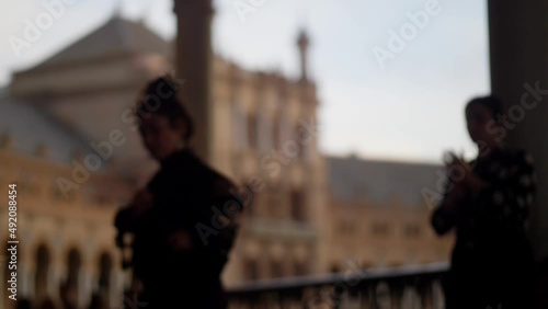 Spanish traditional flamenco dancers in the street, silhouette of unrecognisable female flamenco artists dancing in Seville, street flamenco dancers in Andalusia, Spain