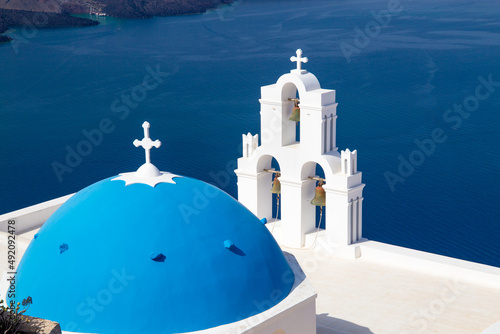 Three Bells of Fira with blue domed church, Santorini island, Greece