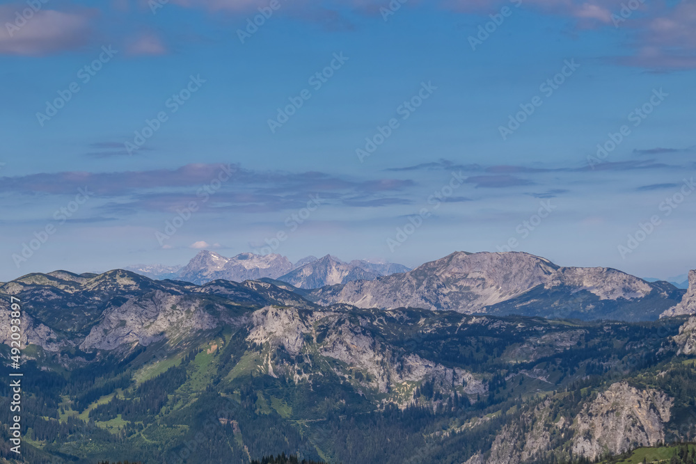 Panoramic view from Messnerin on Hochtor and alpine mountain chains in Styria, Austria, Hochschwab region. Hills overgrown with bushes, higher parts rocky. Summer day. Hiking in Alps, Tragoess