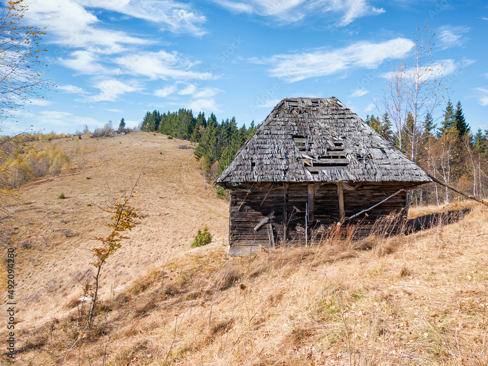 Rustic landscape with an abandoned old wooden house or shelter in the Carpathain Mountains, Romania. Autumn landscape. Rustic landscape with an abandoned old wooden house or shelter in the Carpathain Mountains, Romania. Autumn landscape.