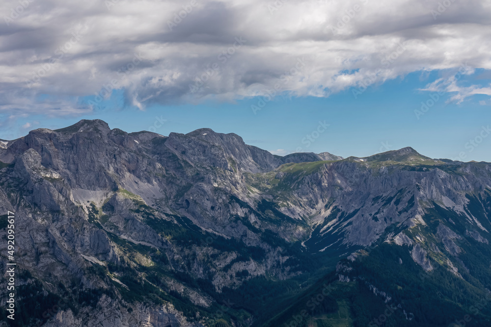 Panoramic view on the alpine mountain chains in Styria, Austria, Hochschwab region. Hills overgrown with small bushes, higher parts rocky and bare. Sunny summer day. Serenity. Hiking in Alps, Tragoess Panoramic view on the alpine mountain chains in Styria, Austria, Hochschwab region. Hills overgrown with small bushes, higher parts rocky and bare. Sunny summer day. Serenity. Hiking in Alps, Tragoess