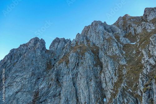 Massive rock wall of mount Eisenerzer Reichenstein in Styria, Austria, Europe. Austrian Alps. Bare and sharp mountain ridges of the Ennstaler Alps. Extreme climbing, mountaineering adventure. Sunny photo