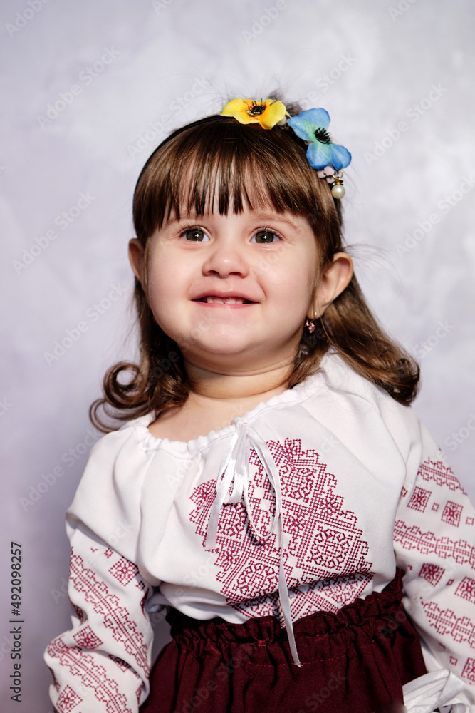 Smiling Baby girl in a beautiful national costume of Ukraine. Ukrainian folk costume Smiling Baby girl in a beautiful national costume of Ukraine. Ukrainian folk costume