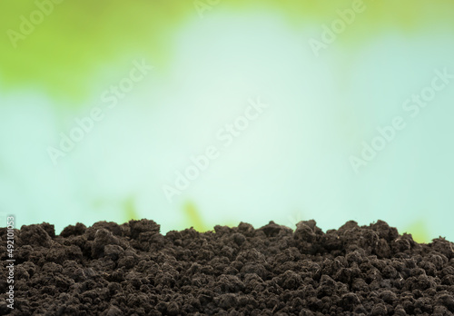 Dark soil surface with sunshine background