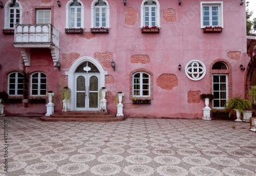 House with pink walls, windows, a very colorful model house in Verona, Italy. © wanchai