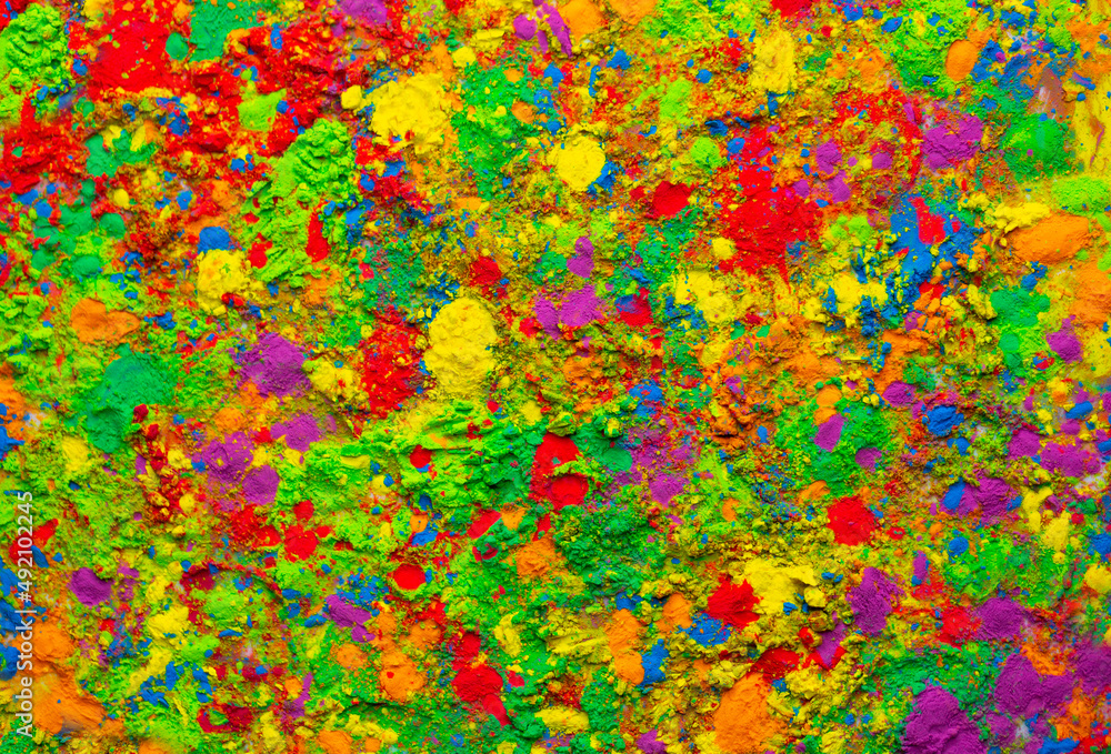 Happy Holi. Colorful background of multicolored gulal powder paints. A colorful festival of colored paints made from powder and dust. Celebration of bright colors of Indian tradition.