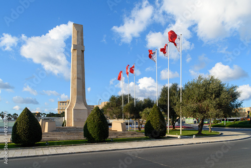 The Obelisk and Maltese flags at the War Memorial in Floriana, Malta, which was first  inaugurated in 1938 photo