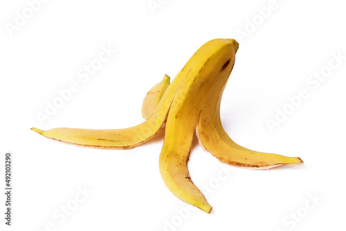 Close-up of a banana peel on the ground on a white background. Concept of organic waste