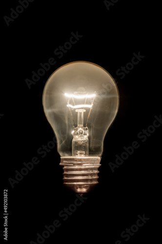 Gowing light bulb close up on black background