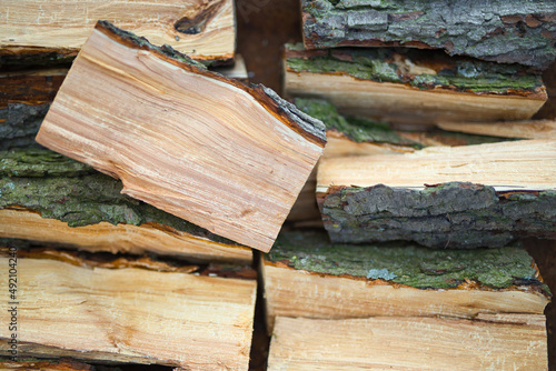textured firewood background of chopped wood for kindling and heating the house. a woodpile with stacked firewood.
