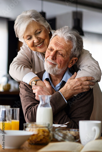 Принти на полотні Senior happy couple in love together smiling and having fun in kitchen