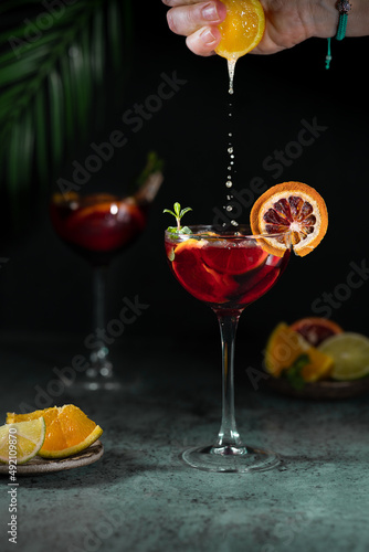 Photos Refreshing sangria or punch with citrus orange lemon fruit in glasses