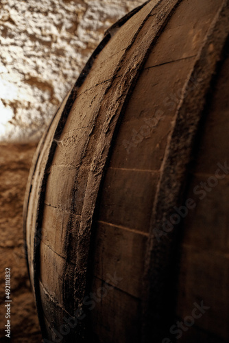 wooden wine barrels in an old historic cellar basement