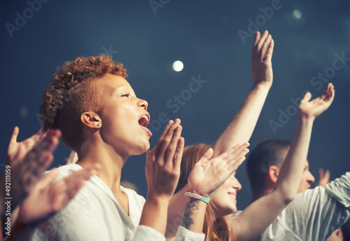 The most epic show of their lives. Young people getting into the music at an awesome concert.