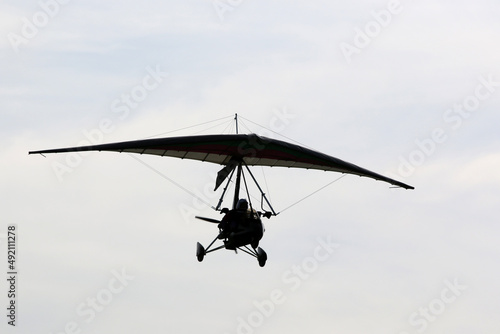 Fototapeta Naklejka Na Ścianę i Meble -  Ultralight airplane flying in a blue sky	