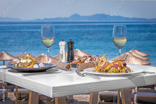 Fototapeta Naklejka Na Ścianę i Meble -  Table in the restaurant with mediteranina food near the sea